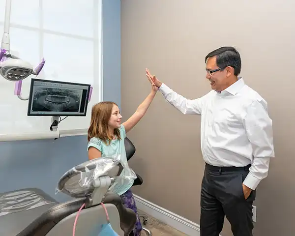  Our doctor giving a young patient a high-five at Picasso Dental Care