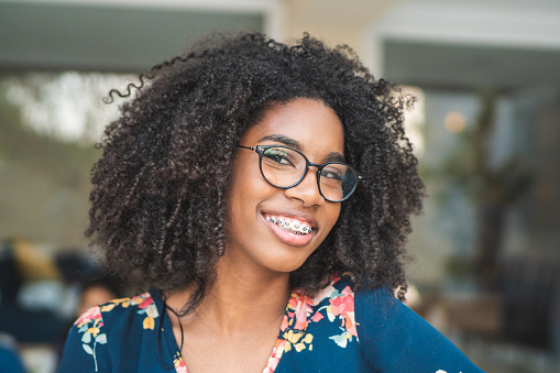 Young woman with braces looking into the camera