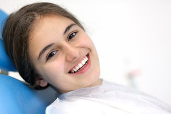 Smiling teenager sitting in dental chair at Picasso Dental Care in Temecula, CA 